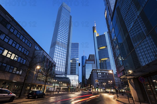 Illuminated city street with skyscrapers