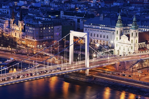 Riverfront cityscape with Elisabeth Bridge and Franciscan Church