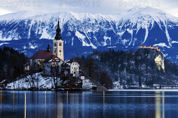 View of Church of the Assumption with lake and mountain