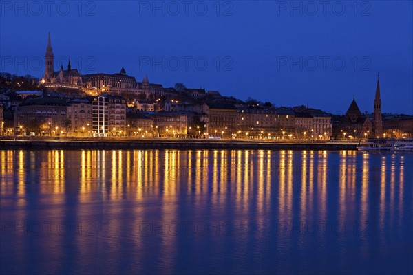 Illuminated skyline reflecting in Danube River