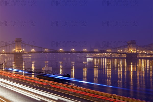 Illuminated Chain Bridge and light trails