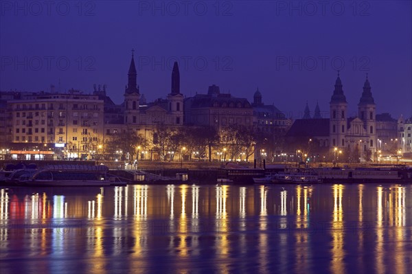 Illuminated waterfront and reflections in river