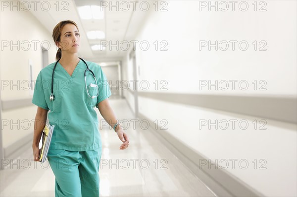 Young female doctor in hospital corridor.