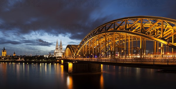 Hohenzollern Bridge illuminated at dusk