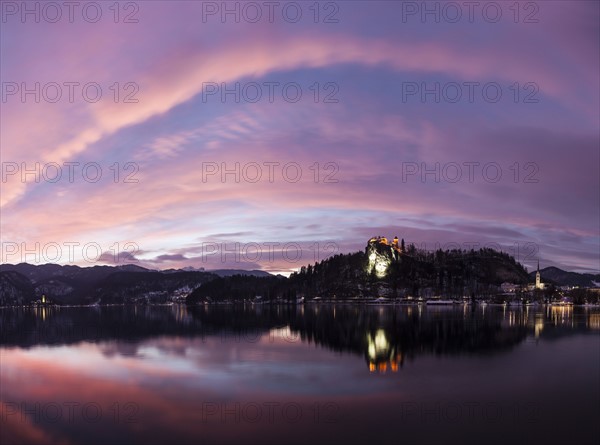 Clouds over Lake Bled and illuminated Church of the Assumption