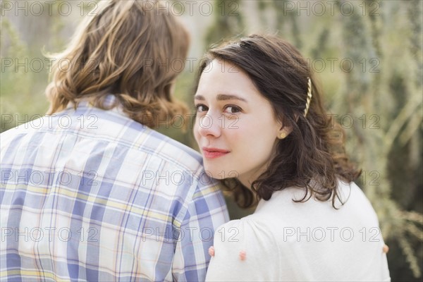 Young smiling woman next to boyfriend