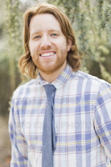 Portrait of smiling man wearing plaid shirt