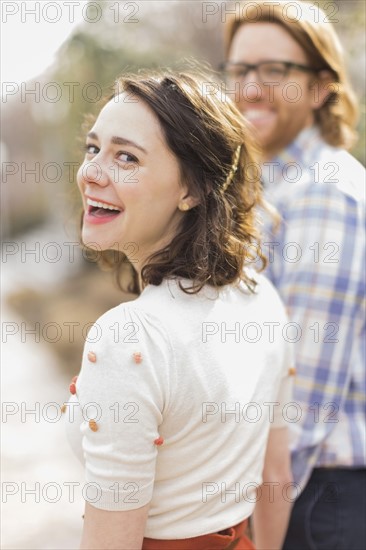 Young smiling woman next to boyfriend