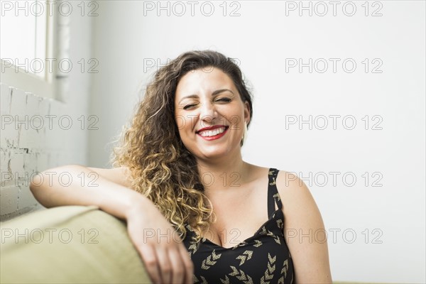 Woman laughing with closed eyes