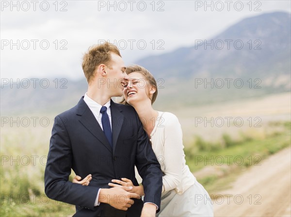 Smiling newlywed couple embracing