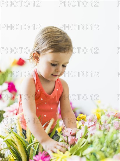 Little girl (2-3) playing with flowers