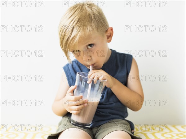 Young boy (2-3) drinking milkshake