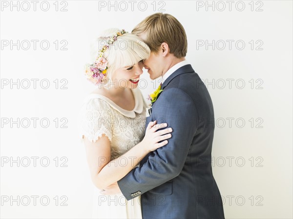 Smiling newlywed couple embracing