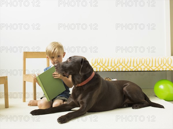 Little boy (2-3) playing with dog