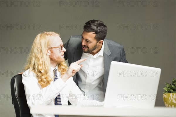 Businessmen talking in office