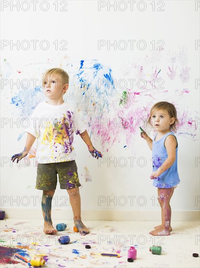 Children (2-3) painting on wall