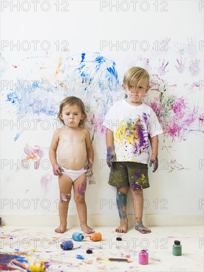 Children (2-3) painting on wall