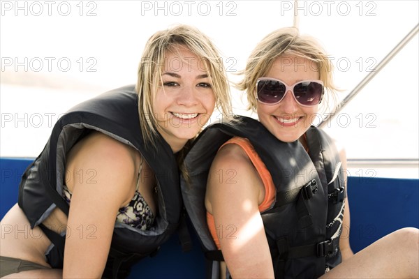 Two young women wearing life jackets