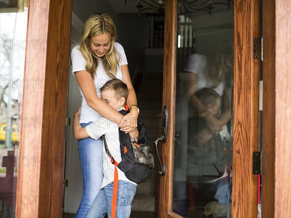 Boy (6-7) hugging mother before leaving for school