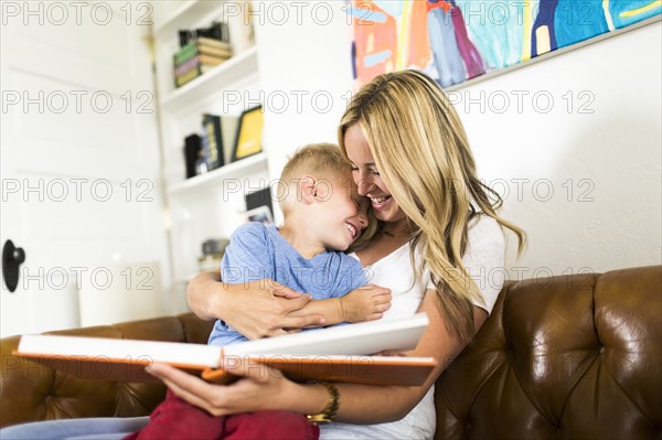 Mother reading book to son (4-5)