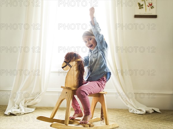 Girl (4-5)on rocking horse