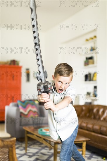 Boy (6-7) playing with sword