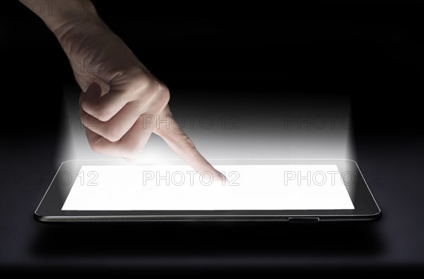 Woman touching digital tablet in studio.