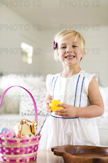 Portrait of girl (2-3) holding candy