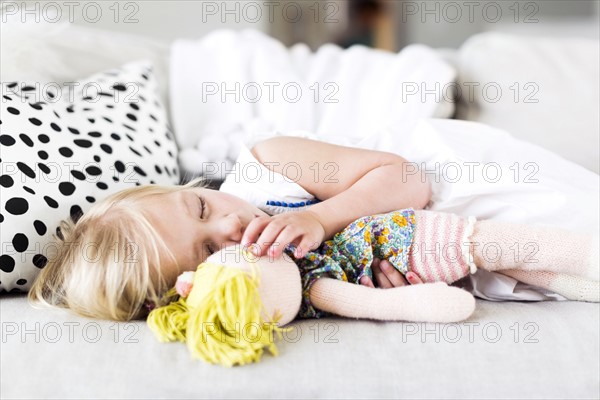 Girl (2-3) napping on sofa