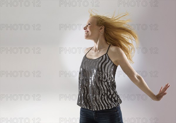 Happy woman dancing in studio.