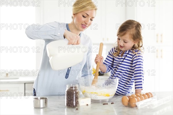 Mother and daughter (4-5) baking
