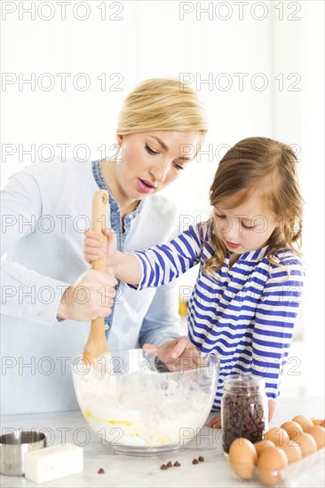 Mother and daughter (4-5) baking