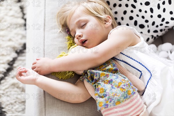 Girl (2-3) napping on sofa