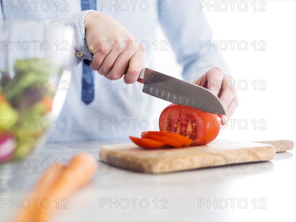 Mid-adult woman preparing salad