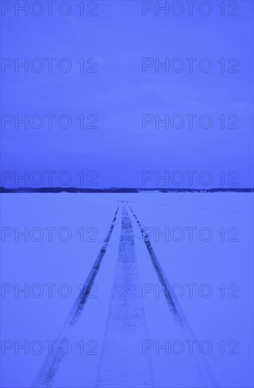 Snowmobile tracks on frozen lake