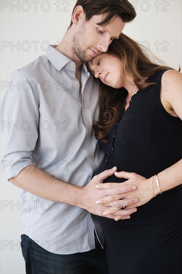 Portrait of content couple holding hands.