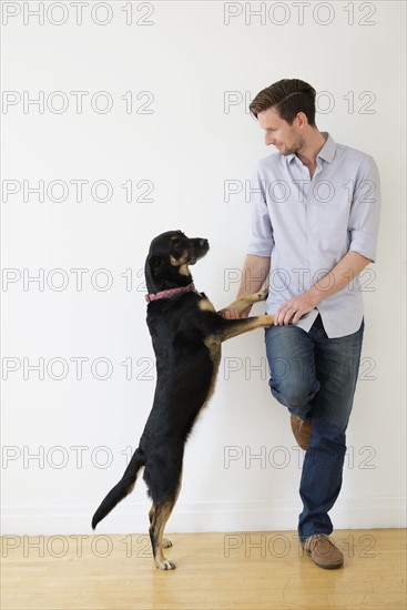 Man playing with dog.