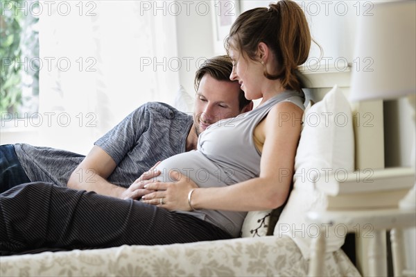 Couple lying in bed.