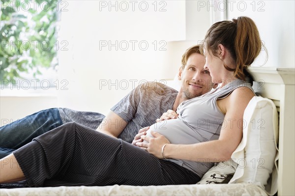 Couple lying in bed.