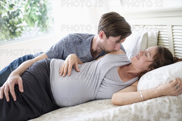 Couple lying in bed.