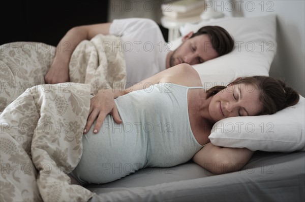 Couple sleeping in bed.