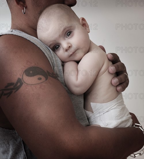 Portrait of baby girl (2-5 months) with her father.