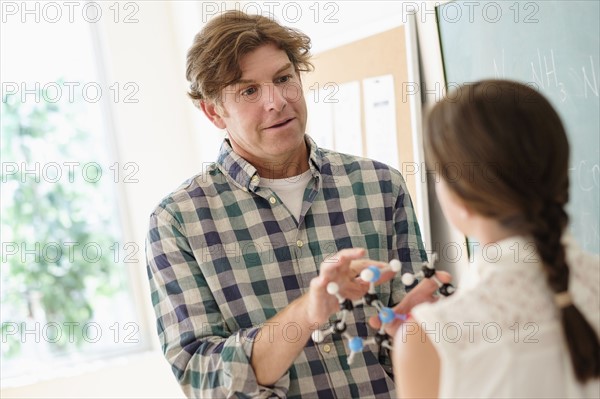 Teacher talking with girl (10-11).