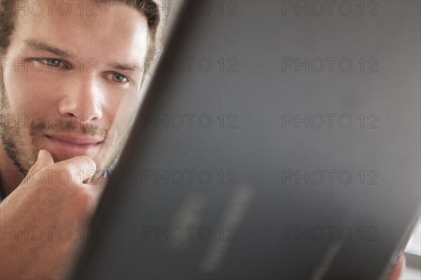 Mid-adult man using tablet pc.