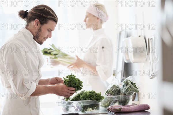 Chefs working in kitchen.