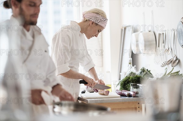 Chefs working in kitchen.