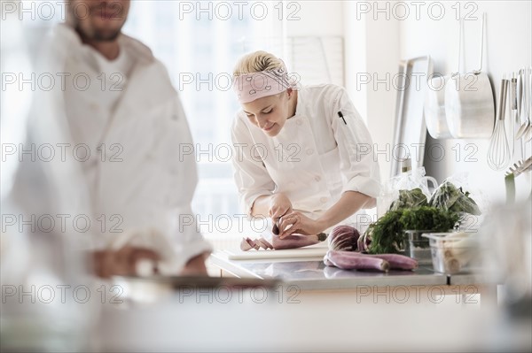 Chefs working in kitchen.