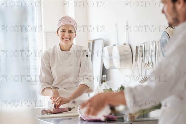 Chefs working in kitchen.