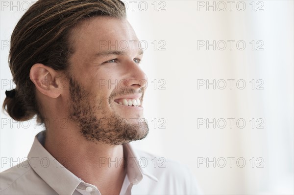 Mid-adult man laughing.