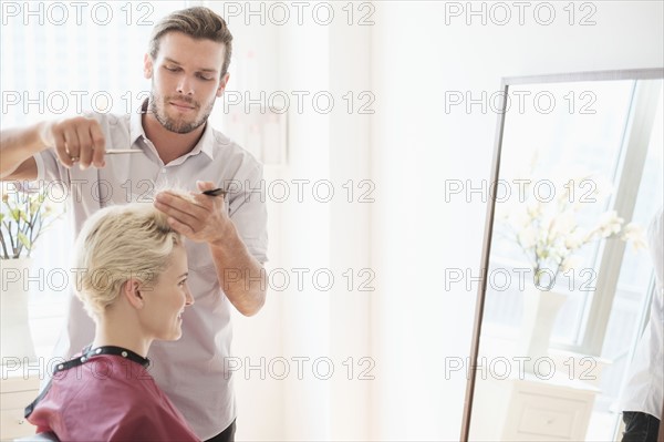Hairdresser cutting woman's hair.